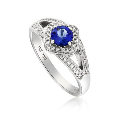An 18ct white gold blue sapphire ring encrusted with diamonds across the shank