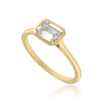 Emerald cut bezel set diamond engagement ring yellow gold angled