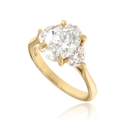 Oval half moon lab grown diamond trilogy engagement ring yellow gold