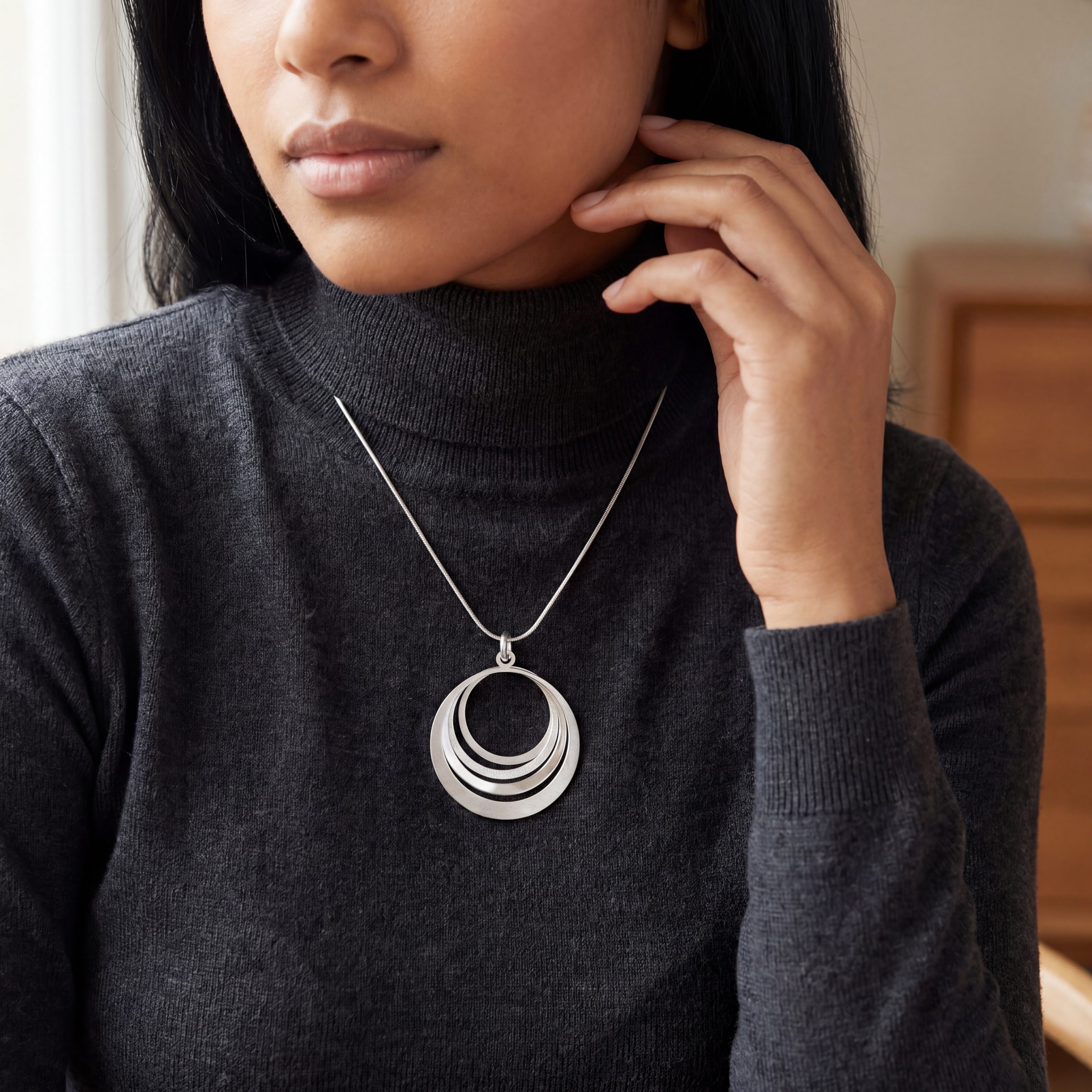 model wearing four circle swirl pendant