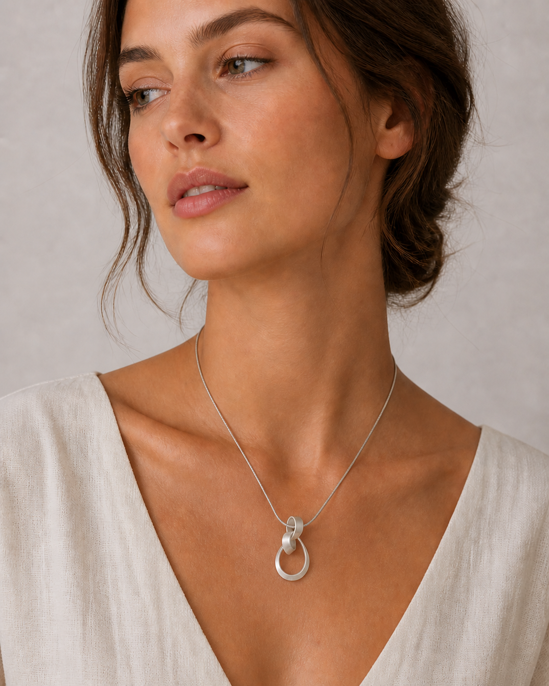 model wearing silver twist swirl pendant