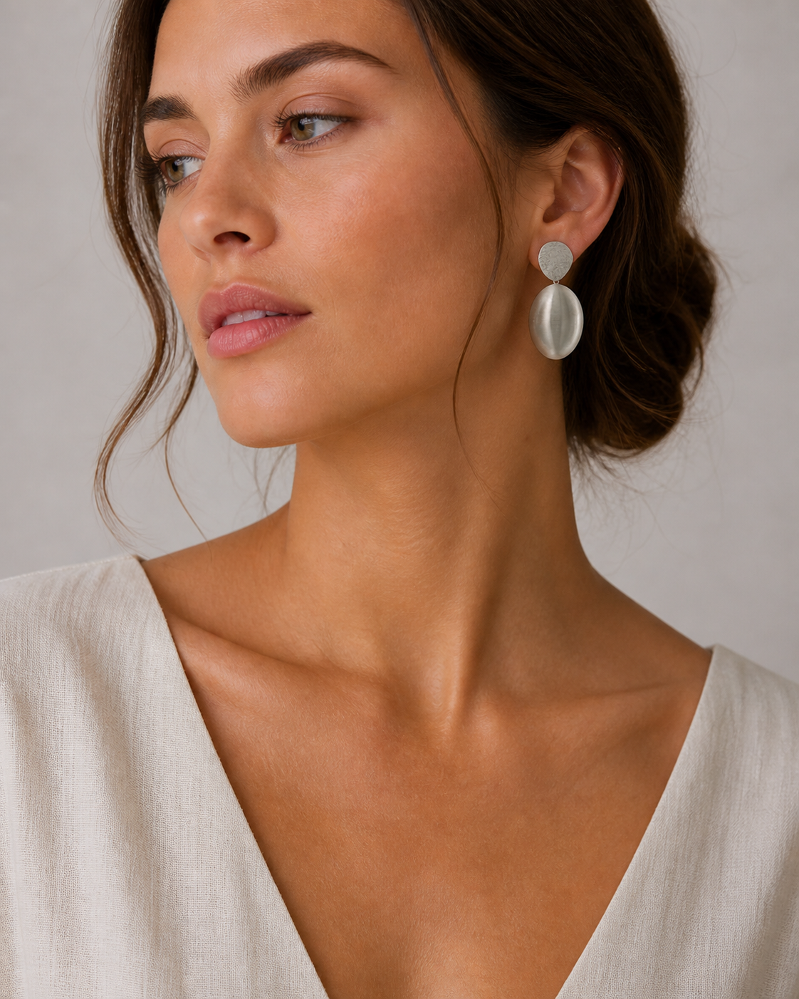 25307 model model wearing oval ball silver drop earrings